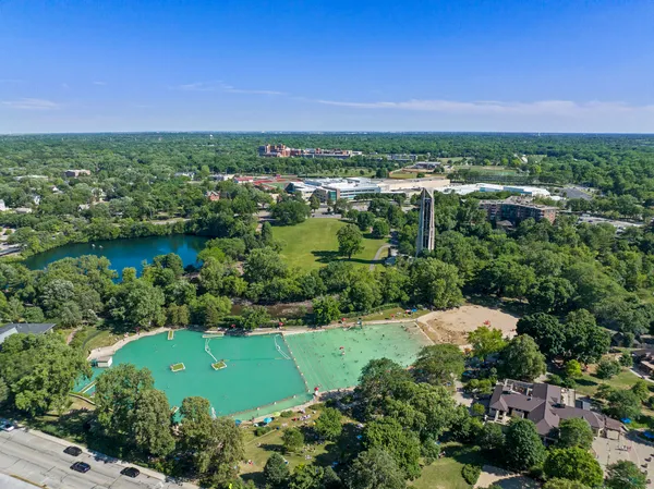 an aerial view of a residential houses with outdoor space and a lake view