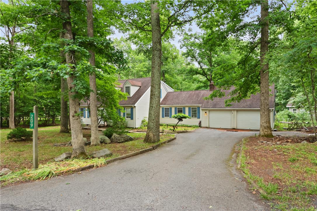 209 Remington Road East Stroudsburg, PA 18301 - Photo 37 of 41 A private driveway leads to a charming house nestled among a canopy of mature trees.