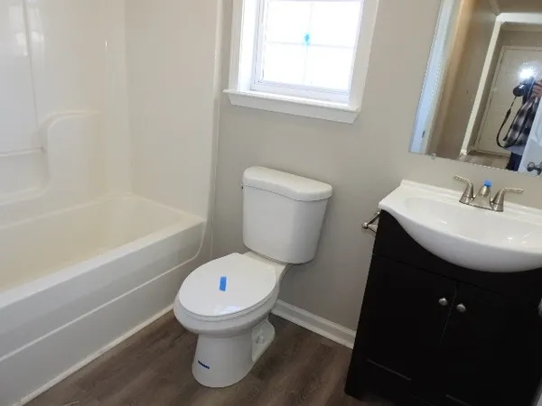 a bathroom with a sink toilet and bathtub