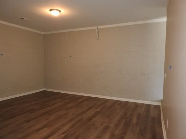 a view of a room with wooden floor