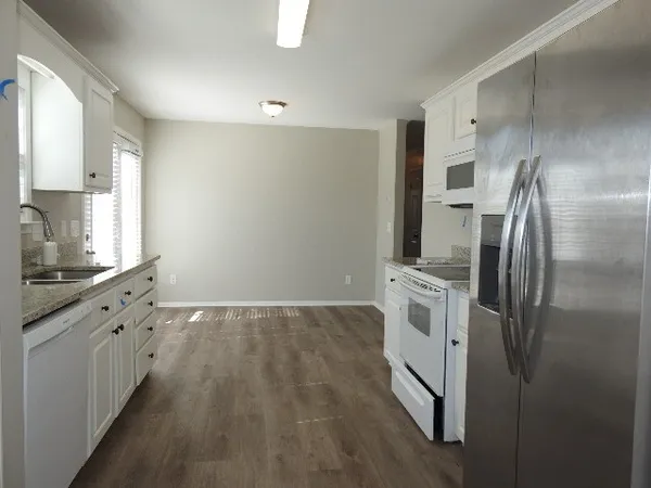 a kitchen with stainless steel appliances a refrigerator sink and cabinets