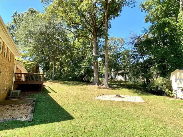 a swimming pool with outdoor seating and yard