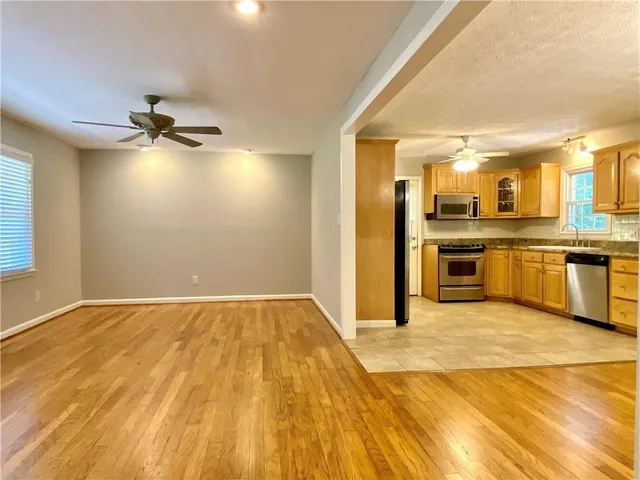 a view of a kitchen with a stove cabinets and wooden floor