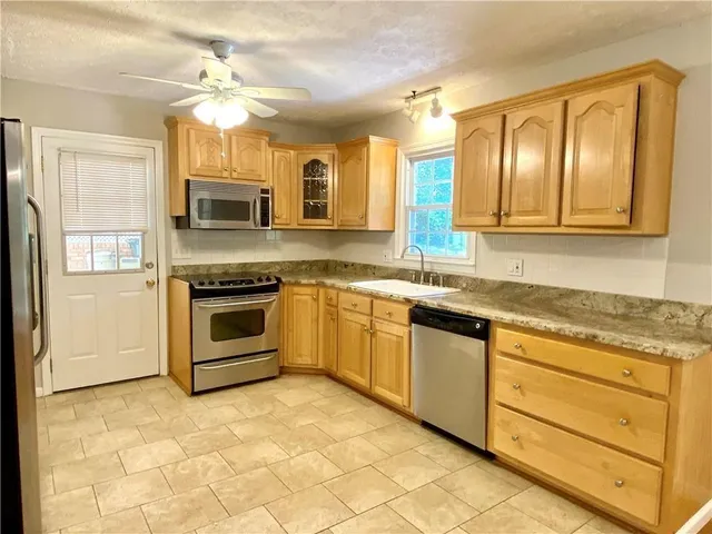 a kitchen with stainless steel appliances granite countertop a stove and a sink