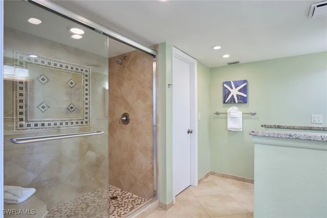 a bathroom with a shower sink and mirror