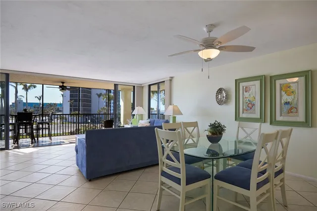 a view of a dining room with furniture and a chandelier