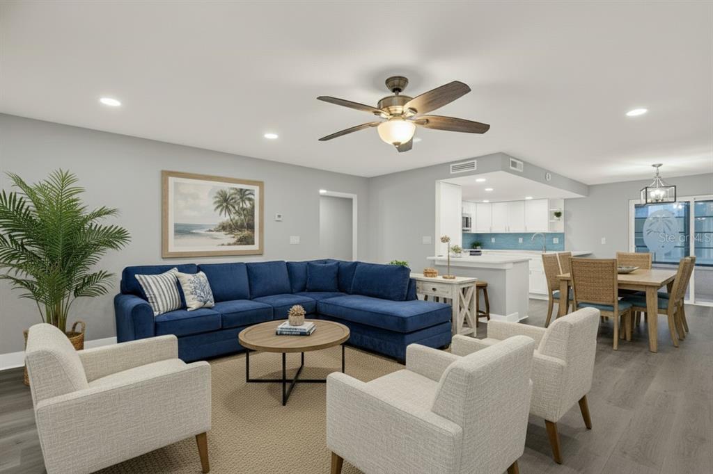 337 Rex Place, Unit A Madeira Beach, FL 33708 - Photo 7 of 48 a living room with furniture kitchen view and a chandelier