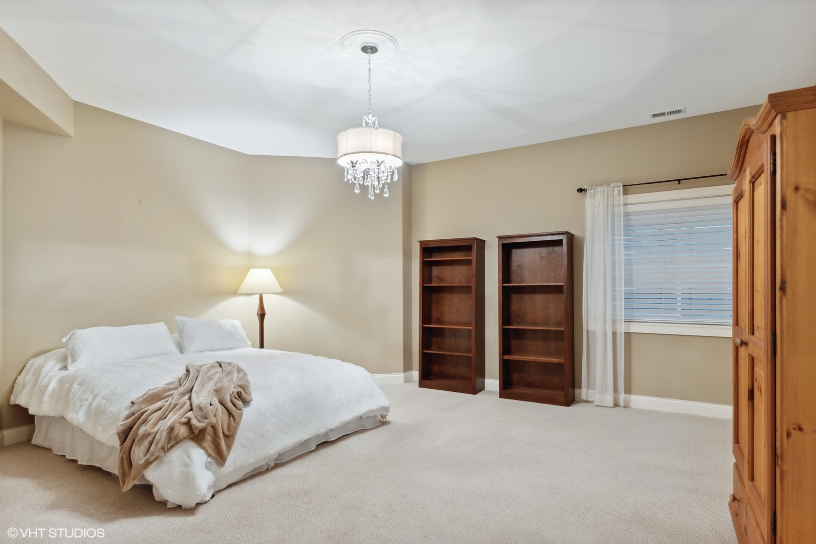 3825 Oak Avenue Northbrook, IL 60062 - Photo 38 of 56 a spacious bedroom with a bed and a chandelier