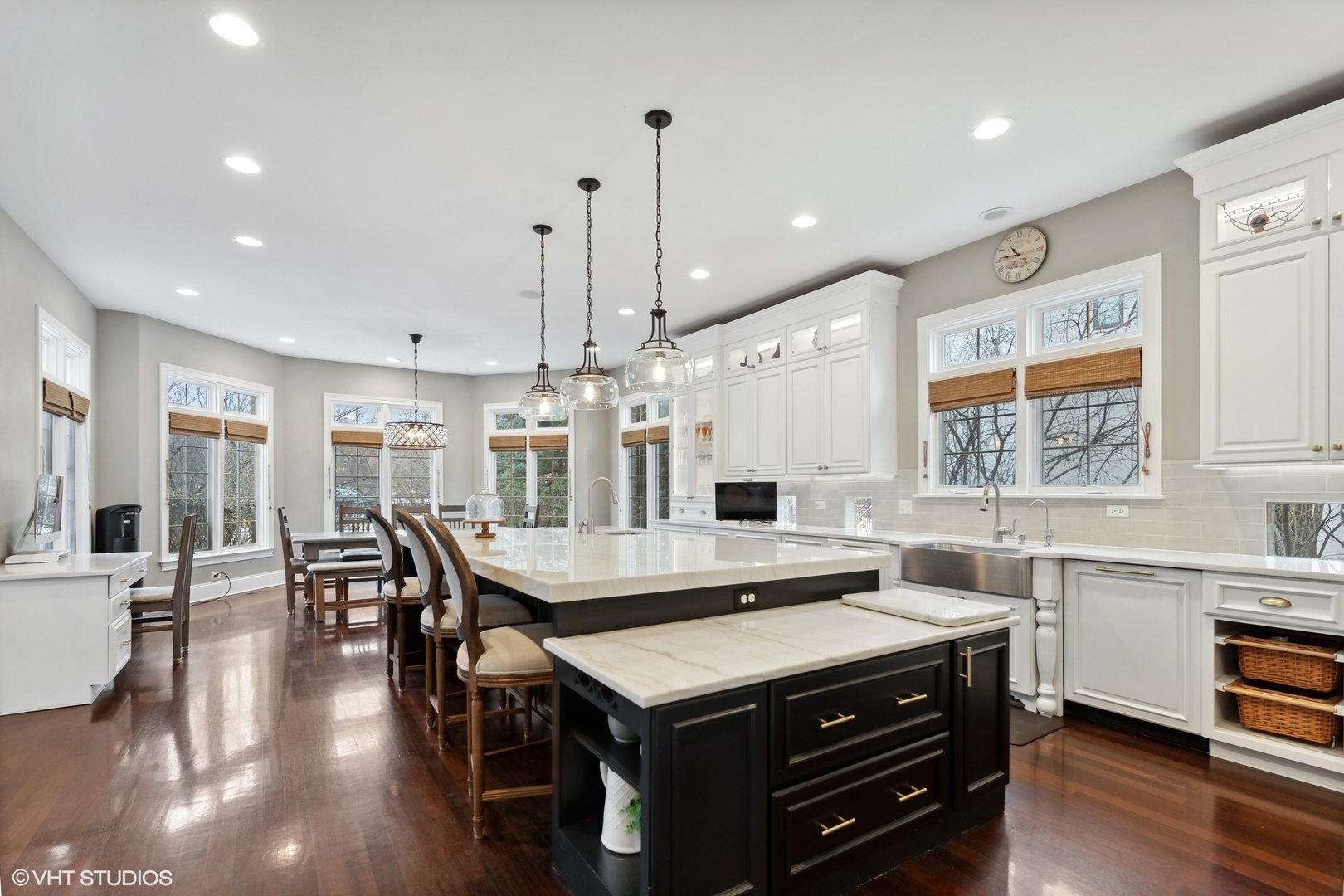 3825 Oak Avenue Northbrook, IL 60062 - Photo 7 of 56 a kitchen with a stove a sink dishwasher a dining table and chairs with wooden floor