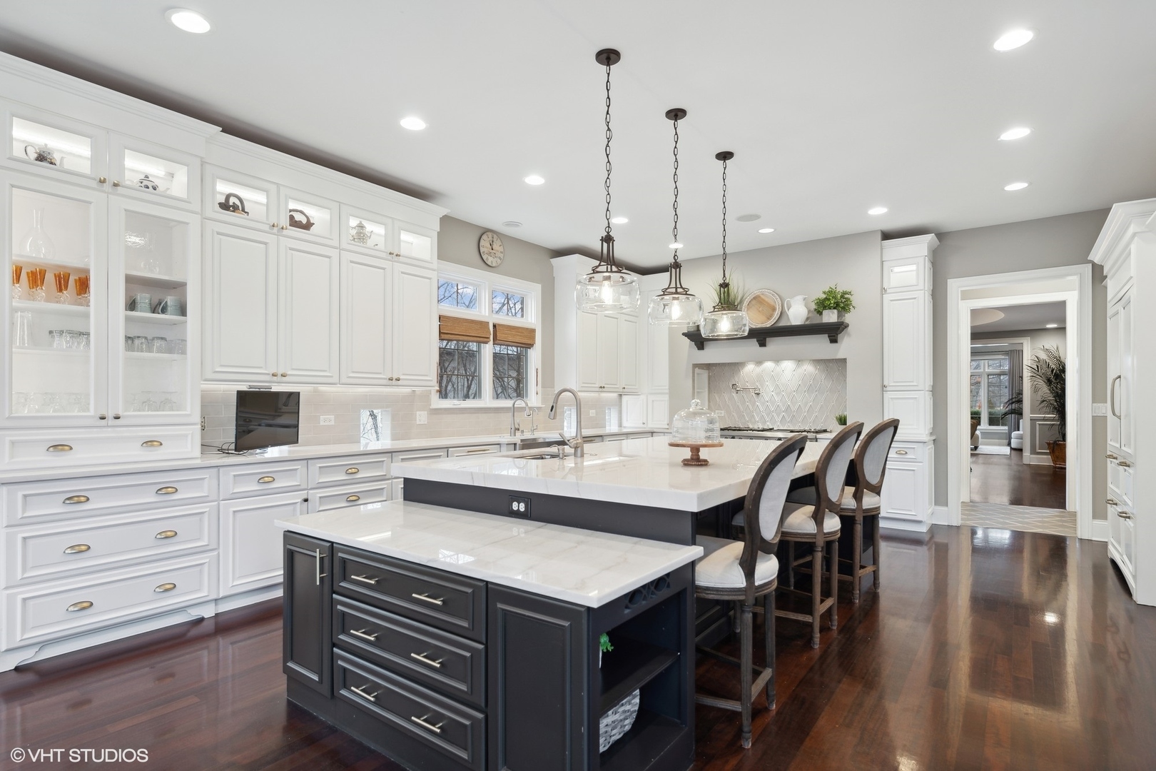 3825 Oak Avenue Northbrook, IL 60062 - Photo 10 of 56 a kitchen with stainless steel appliances kitchen island granite countertop a table chairs sink and cabinets