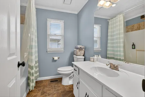a bathroom with a sink toilet a mirror and shower