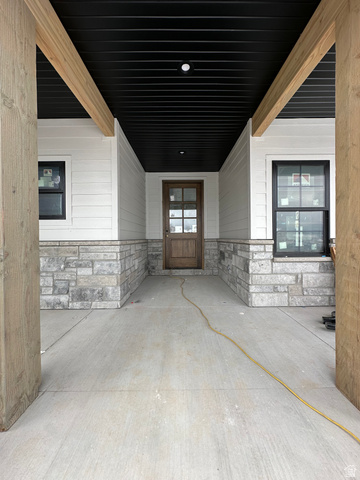 143 South Chamberlain Street, Unit 327 Mapleton, UT 84664 - Photo 3 of 12 Property entrance featuring stone siding and a patio area