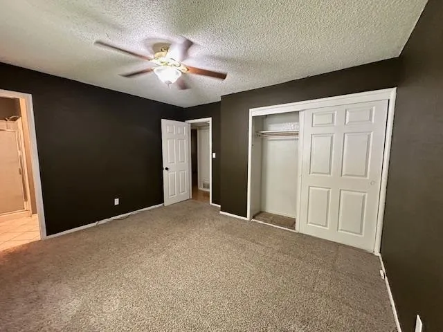 a bathroom with a granite countertop sink toilet a mirror and shower