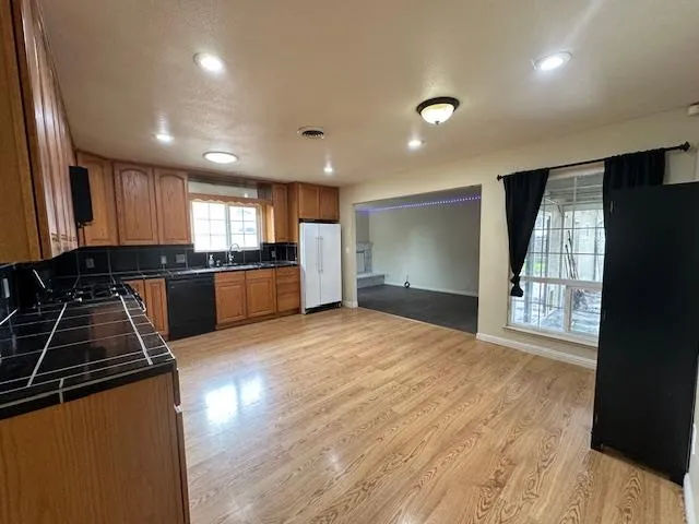 a kitchen with granite countertop a stove and a refrigerator