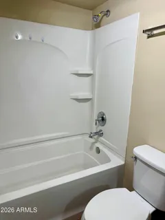 a bathroom with a granite countertop toilet and a sink