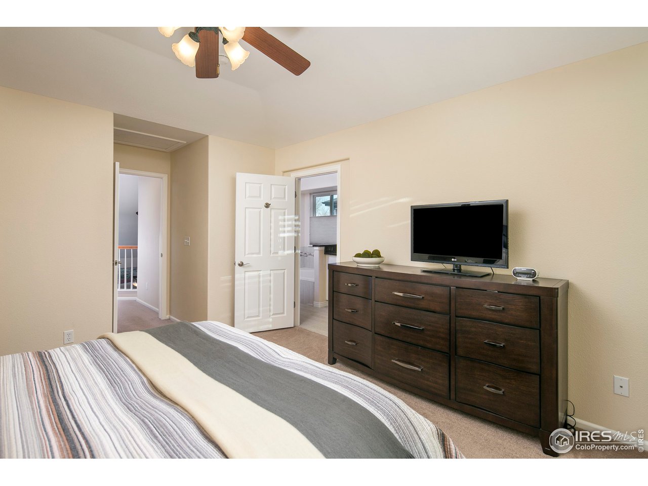 1692 Eldorado Drive Superior, CO 80027 - Photo 17 of 34 a bedroom with a bed and a flat screen tv