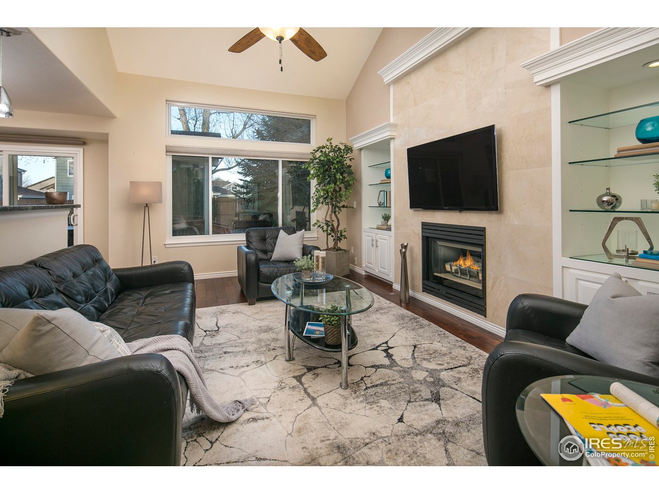 1692 Eldorado Drive Superior, CO 80027 - Photo 7 of 34 a living room with furniture a flat screen tv and a fireplace