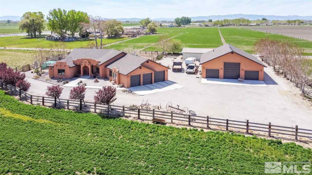a view of a house with a yard and lake view