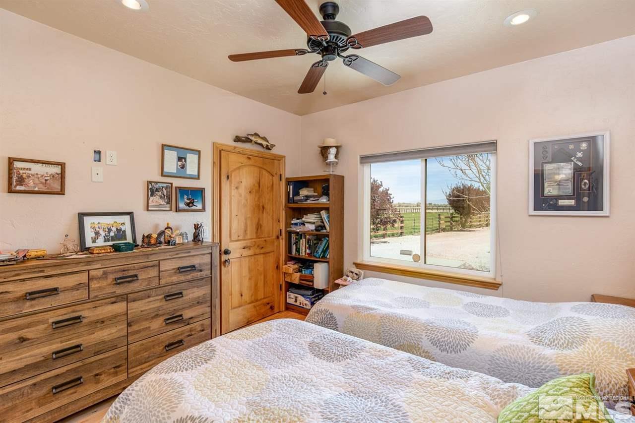 3500 South Allen Road Fallon, NV 89406 - Photo 21 of 40 a bedroom with a bed and a flat tv screen on dresser