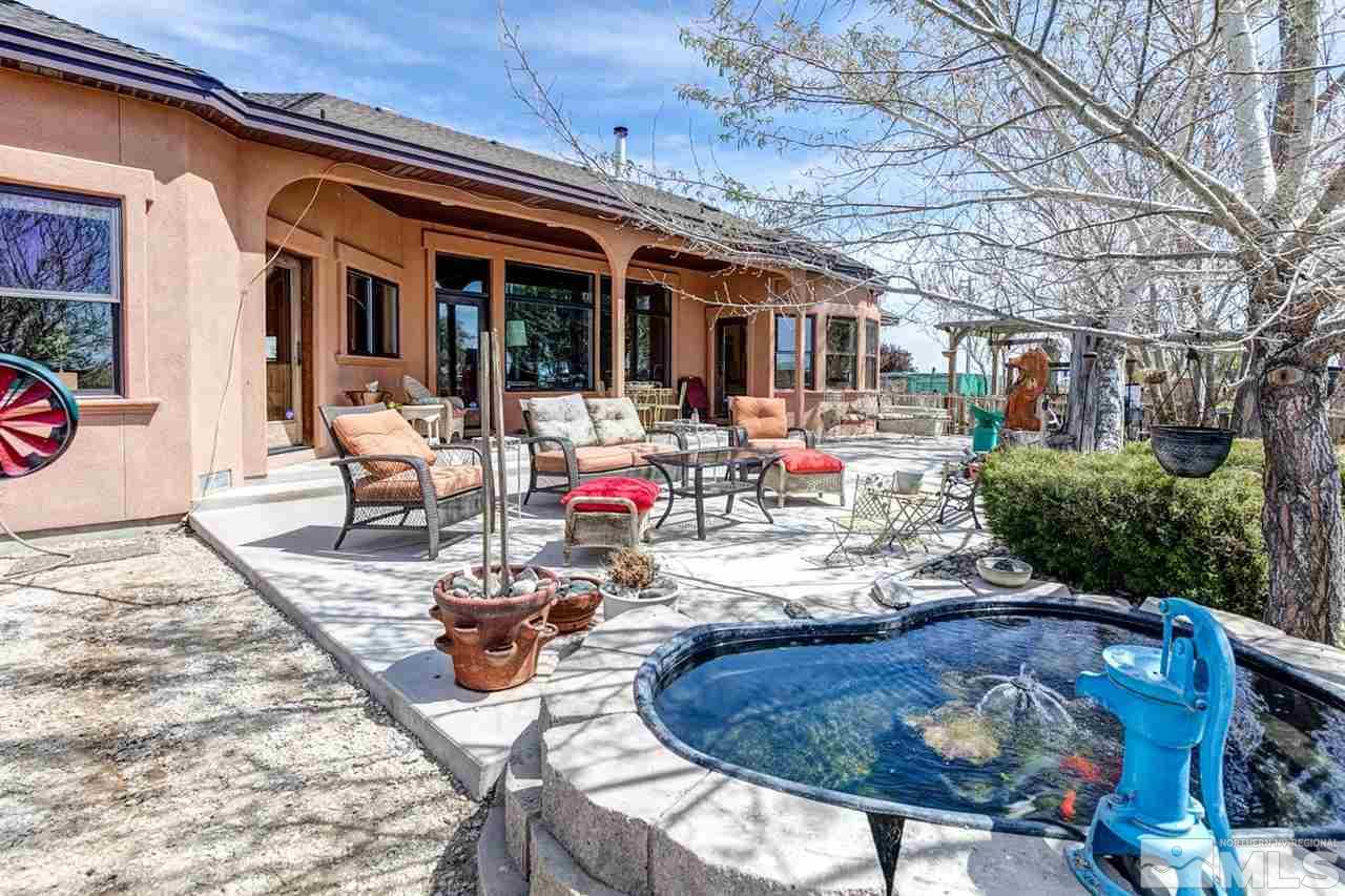 3500 South Allen Road Fallon, NV 89406 - Photo 32 of 40 a view of a patio with table and chairs potted plants and large tree