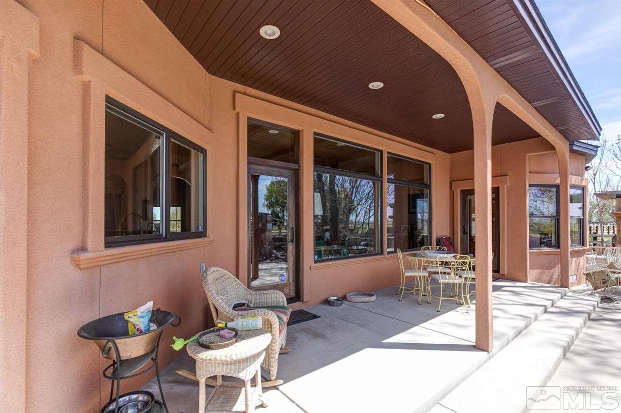 3500 South Allen Road Fallon, NV 89406 - Photo 33 of 40 a view of a patio with table and chairs and floor to ceiling window
