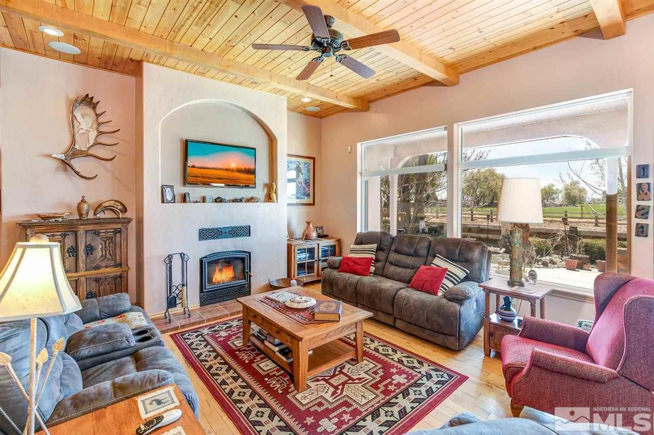 3500 South Allen Road Fallon, NV 89406 - Photo 6 of 40 a living room with furniture a flat screen tv and a fireplace