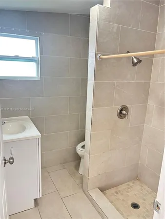 a bathroom with a shower and toilet
