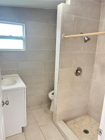 a bathroom with a shower and toilet