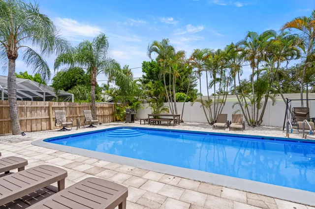 a view of outdoor space with swimming pool and lounge chair