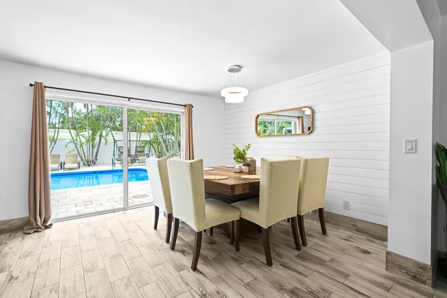 a dining room with furniture and wooden floor