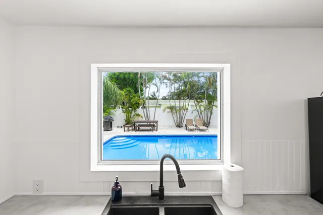 a view of a small sitting area with furniture and floor to ceiling window