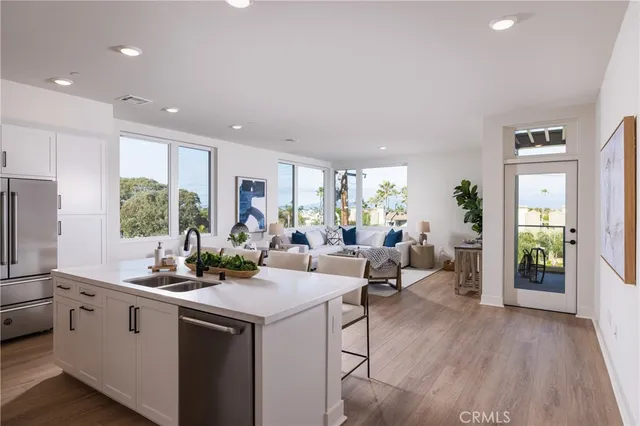 a kitchen with a large window appliances and cabinets
