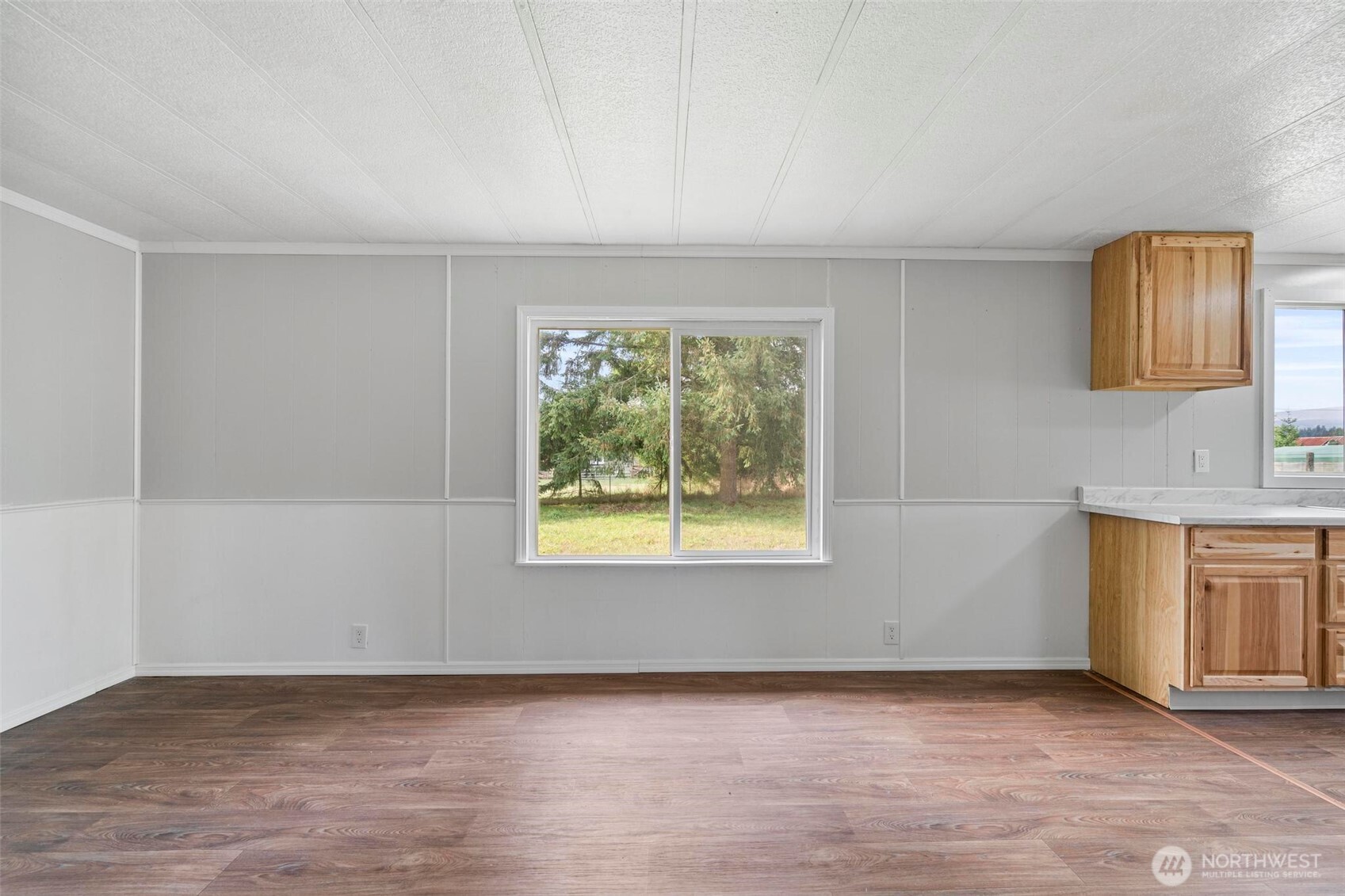 8826 183rd Avenue Southwest Rochester, WA 98579 - Photo 11 of 31 a view of an empty room with a window and a fireplace