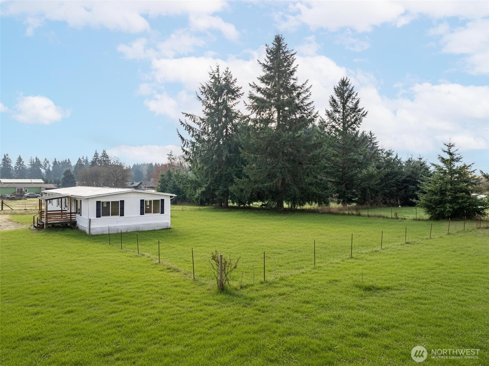 8826 183rd Avenue Southwest Rochester, WA 98579 - Photo 27 of 31 a view of a ocean with lawn chairs and large trees
