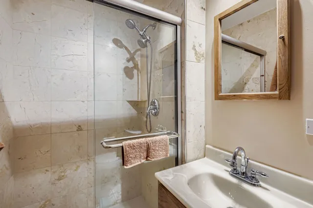 a bathroom with a sink and mirror