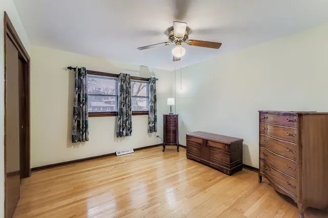 a view of room with window and a ceiling fan