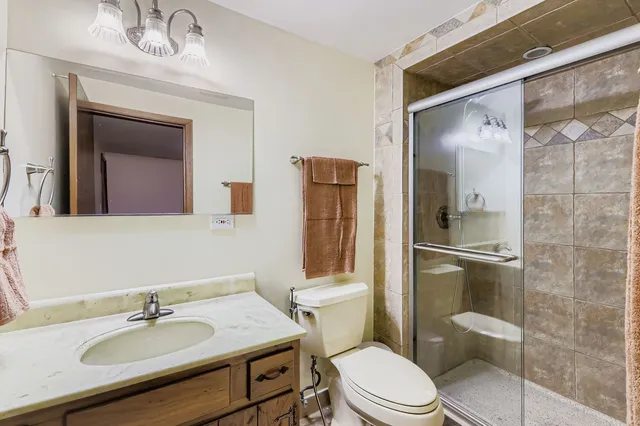 a bathroom with a sink toilet and shower