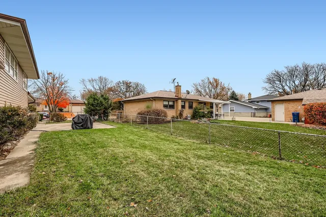 a aerial view of a house with a yard table and chairs