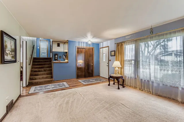 a view of an empty room with a fireplace and a window