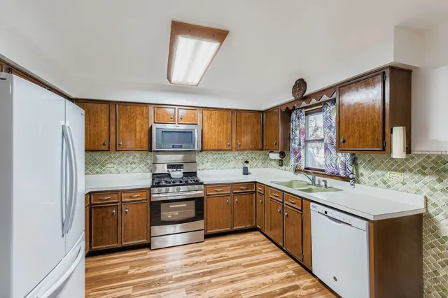 a kitchen with a sink stove and refrigerator