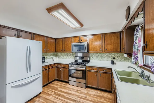 a kitchen with a sink cabinets and refrigerator
