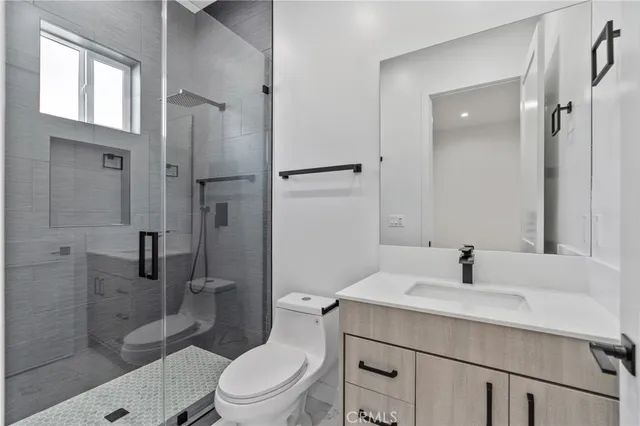a bathroom with a sink toilet and shower