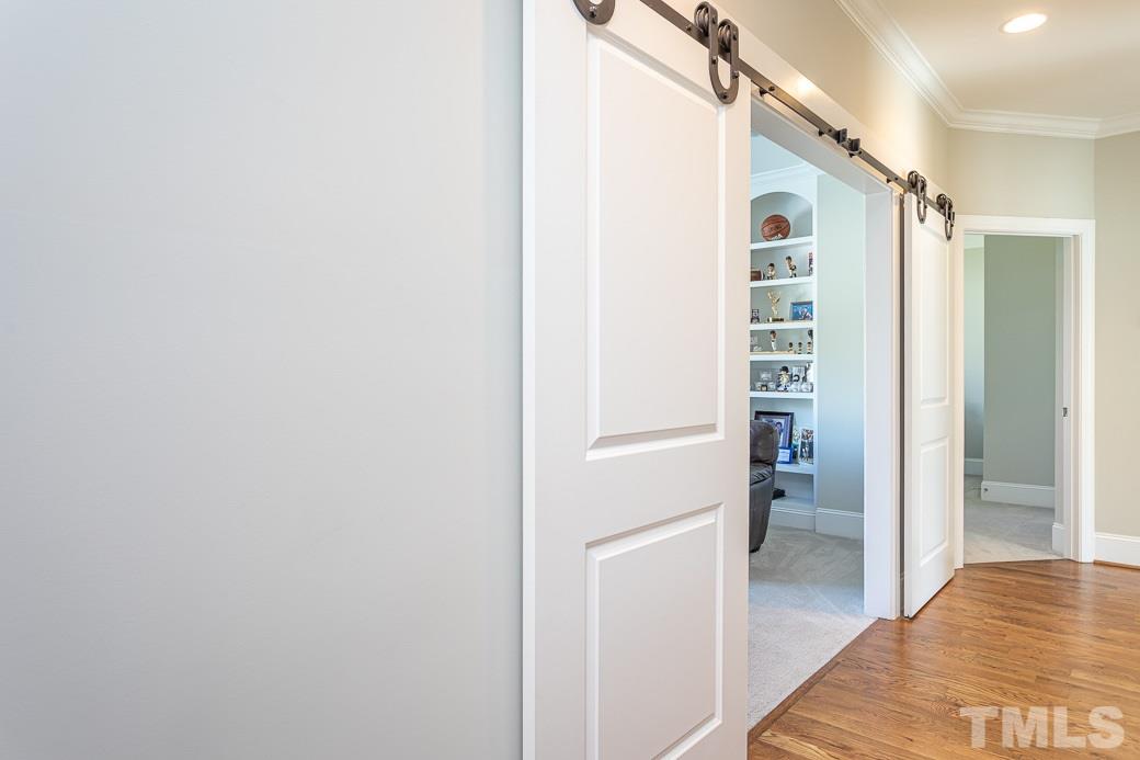 4604 Pleasant Pointe Way Raleigh, NC 27613 - Photo 19 of 30 Second floor hallway with custom built in shelves and site finished hardwoods