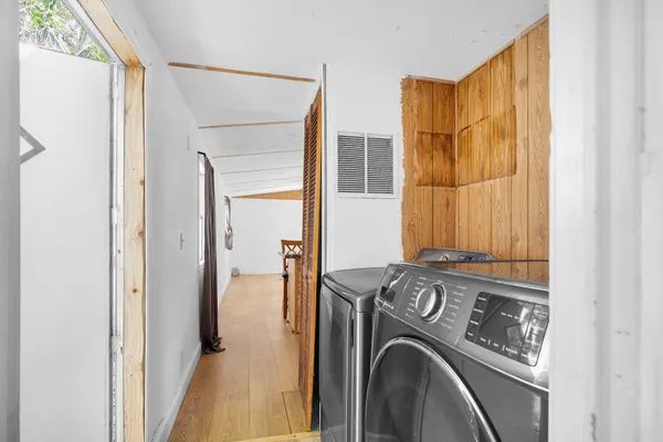 an empty room with windows and closet