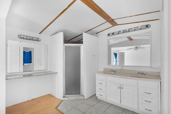 a bathroom with a granite countertop sink mirror and vanity
