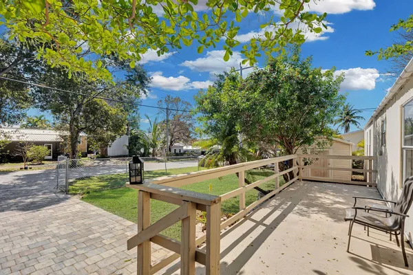 a view of a patio with a table and chairs
