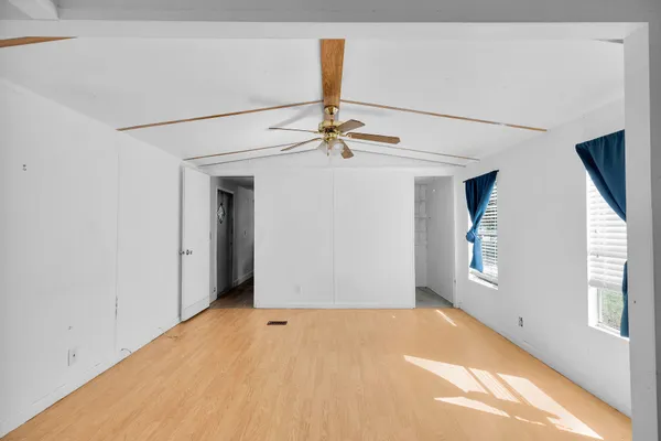 a view of a big room with windows and cabinet