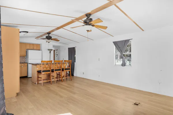 a view of a kitchen with furniture and a ceiling fan