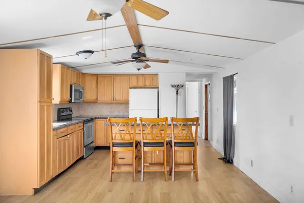a view of a dining room with furniture and wooden floor