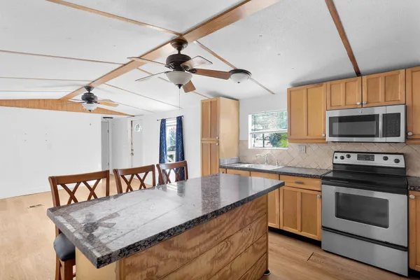 a kitchen with a stove a sink and a microwave